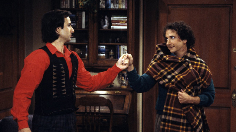 Bronson Pinchot and Mark Linn-Baker's Balki Bartokomous and Larry Appleton fist bump in Perfect Strangers