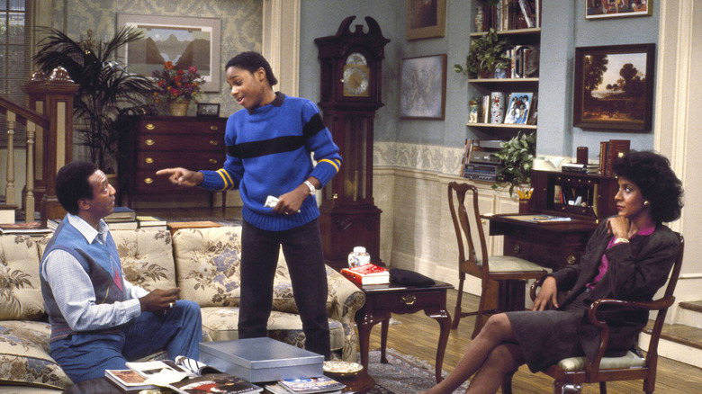 Malcolm-Jamal Warner as Theo Huxtable speaks to parents Cliff and Claire Huxtable, played by Bill Cosby and Phylicia Rashad in The Cosby Show