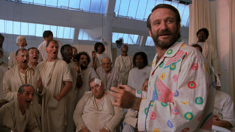 Parry Sagan (Robin Williams) in a colorful pajama set talks to mental patients in The Fisher King