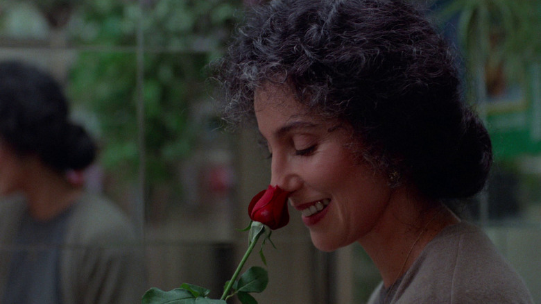 Loretta (Cher) sniffing a rose in Moonstruck