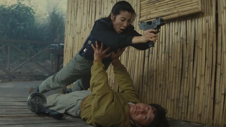Jackie Chan as Chan holds up Michelle Yeoh as Yang, in Supercop