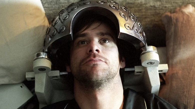 Jim Carrey as Joel Barish in bed a neural device on his head in Eternal Sunshine of the Spotless Mind