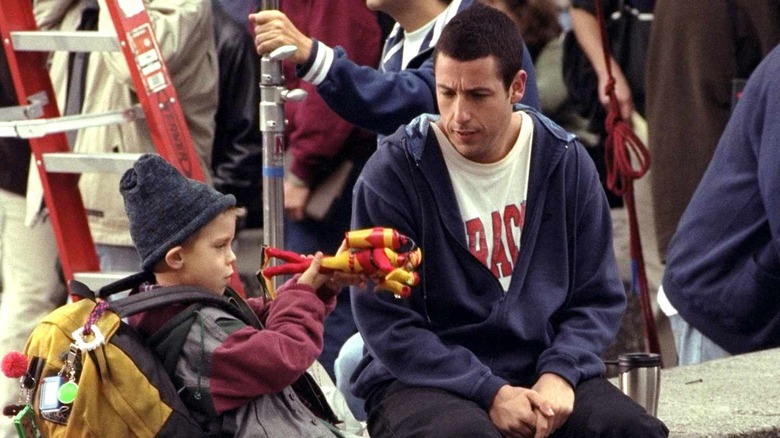 Adam Sandler sitting with Dylan/Cole Sprouse playing with toys in Big Daddy