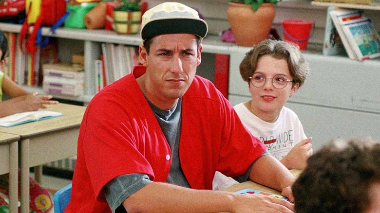 Adam Sandler as Billy Madison sitting next to Jared Cook as Ernie in Billy Madison