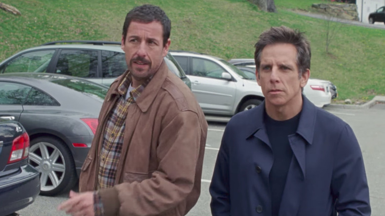 Adam Sandler and Ben Stiller as Danny and Matthew standing in a parking lot in The Meyerowitz Stories