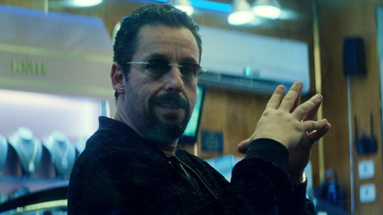 Adam Sandler as Howard sitting in his jewelry store in Uncut Gems