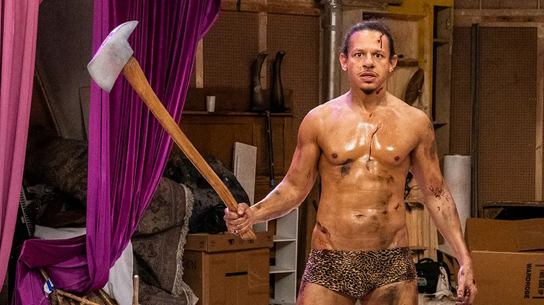 A sweaty Eric Andre in underpants holds an axe in The Eric Andre Show