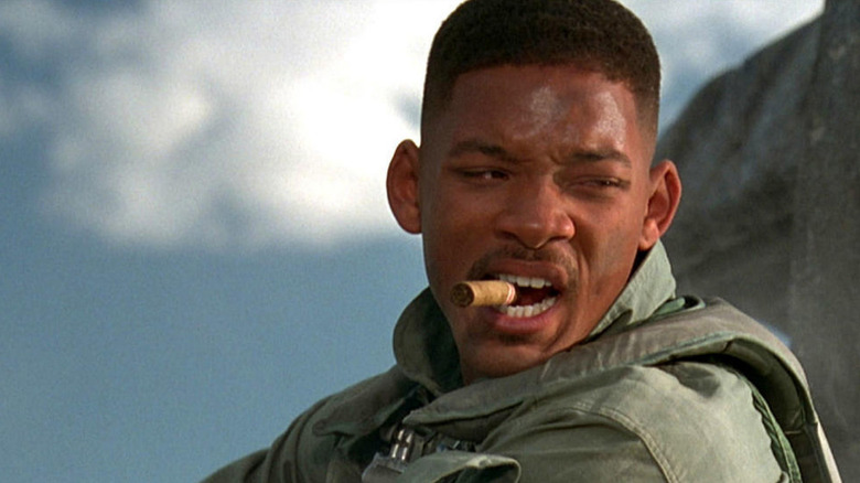 Will Smith as Captain Steven Hiller in Independence Day, looking off to the side while chomping down on a cigar.
