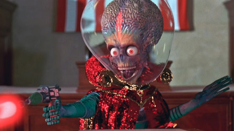 One of the aliens in Mars Attacks! points a ray gun at congress