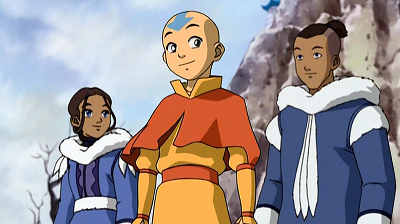 Aang (Zach Tyler Eisen) smiles while flanked by Katara (Mae Whitman) and Sokka (Jack De Sena) in Avatar: The Last Airbender