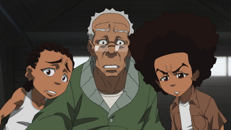 Riley Freeman (Regina King), Granddad Freeman (John Witherspoon), and Huey Freeman (Regina King) react in show in The Boondocks