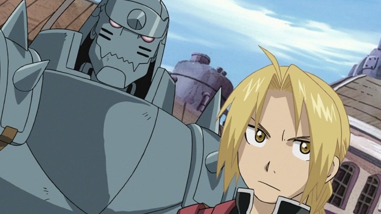 Edward and Alphonse Elric stand next to each other in a city in Fullmetal Alchemist: Brotherhood