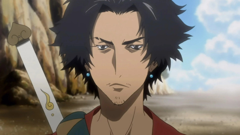 Mugen stands stoically on a cliffside road in Samurai Champloo