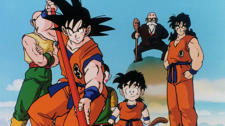 Goku stands in front of Gohan, Roshi, and Yamcha in Dragon Ball Z
