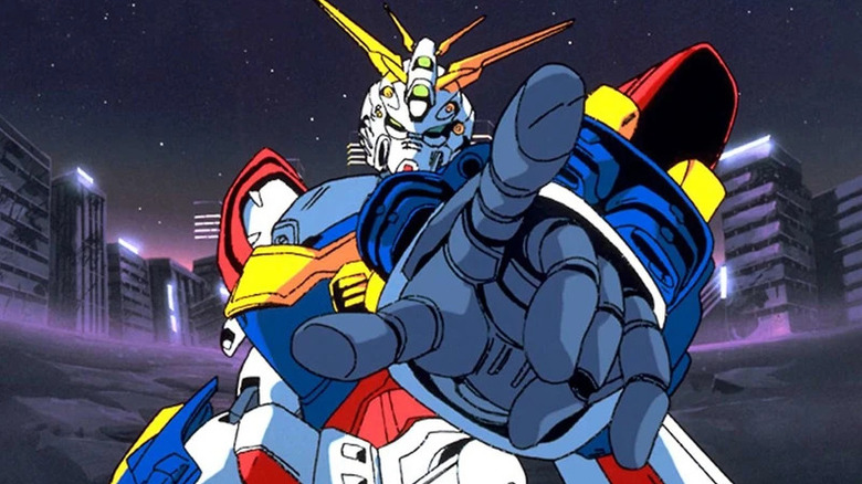 A Gundam points at the screen in front of an abandoned city in Mobile Fighter G Gundam