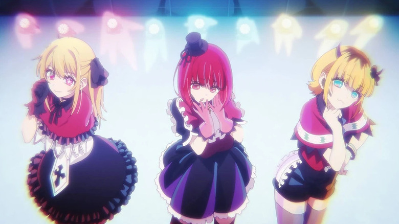 The pop group B-Komachi stands on a brightly lit stage in Oshi no Ko