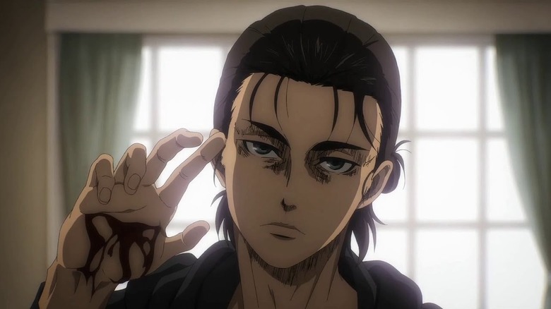 A sullen Eren Yeager shows his bloody hand in Attack on Titan