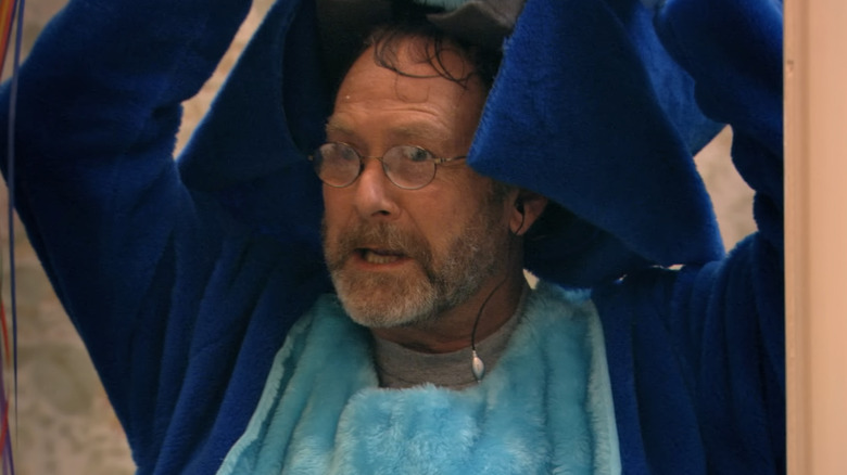 Martin Mull as Gene Parmesan, removing a bear disguise on Arrested Development