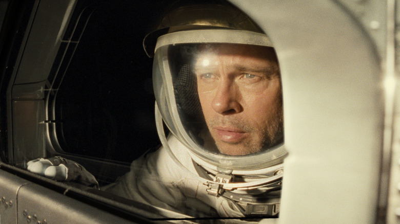 Brad Pitt as Roy McBride in Ad Astra, suited up and looking out at space.