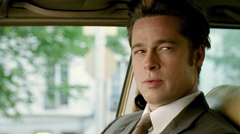 Brad Pitt as Chad in Burn After Reading, squinting at someone off-camera.