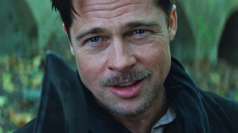 Brad Pitt as Lieutenant Aldo Raine in Inglorious Basterds, holding up his large knife and looking past the camera.
