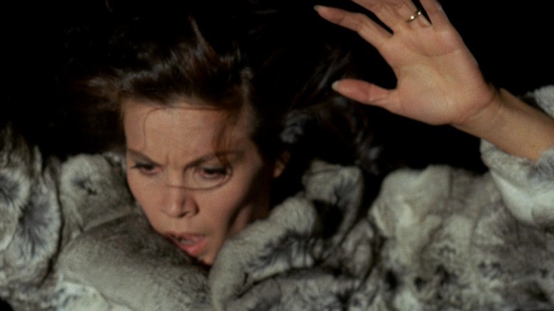 Florinda Bolkan as Carol Hammond looking down with her arms up in A Lizard in a Woman's Skin