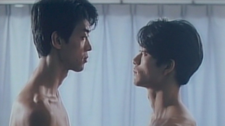 Takeshi Itō as Ryuzaki and Simon Kumai as Kitami facing each other with no shirts on in Muscle