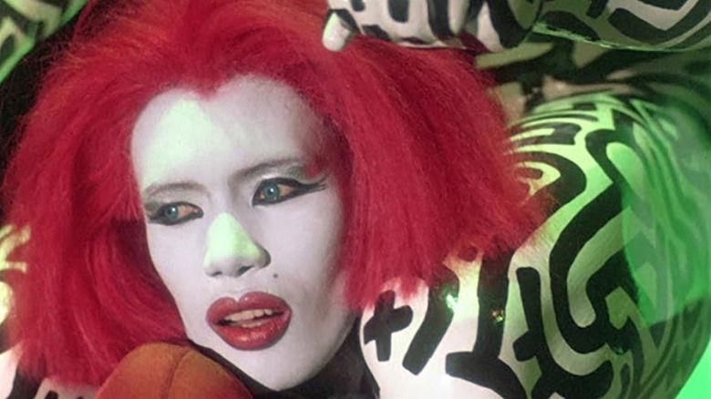 Grace Jones as Katrina performing on stage in ghost makeup in Vamp