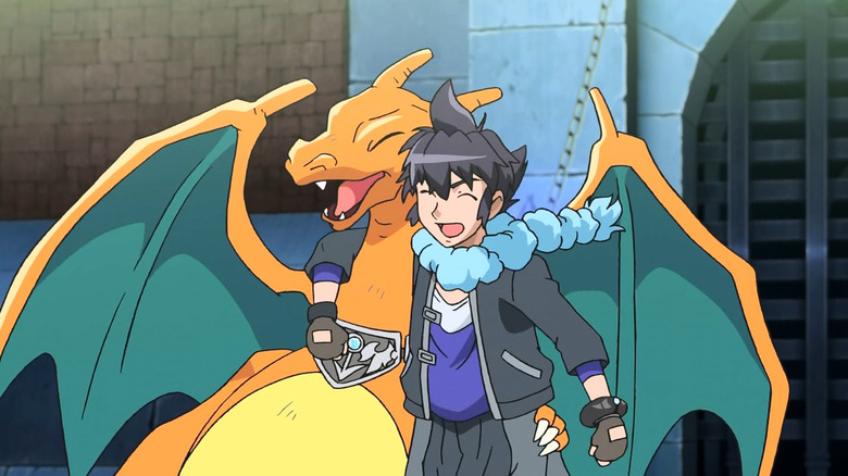 Alain hugging his bruised Charizard and smiling in Pokemon the Series: XY