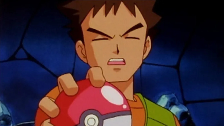 Brock holding a Poke Ball in the original Pokemon anime series
