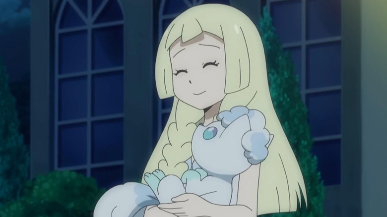Lillie smiling while holding Alolan Vulpix in her arms in Pokemon the Series: Sun & Moon