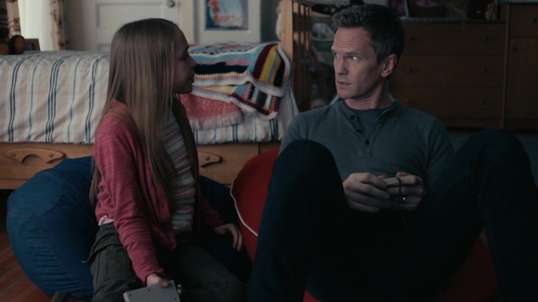 Sophia Reid-Gantzert and Neil Patrick Harris as Annie and Jake Doyle, playing video games together in 8-Bit Christmas