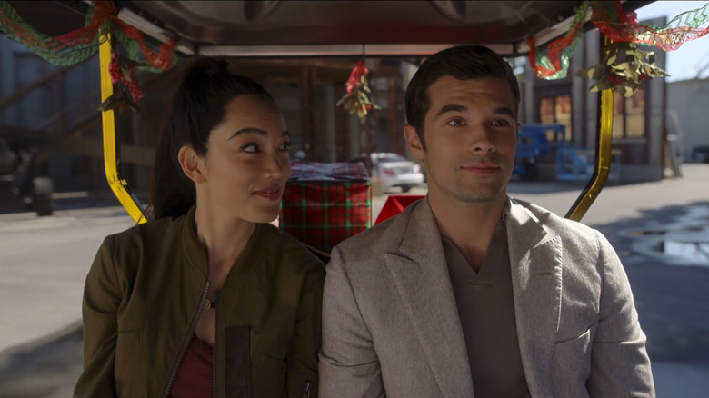 Jessika Van and Josh Swickard as Jessica and Christopher, sharing a golf cart on a Hollywood lot in A Hollywood Christmas
