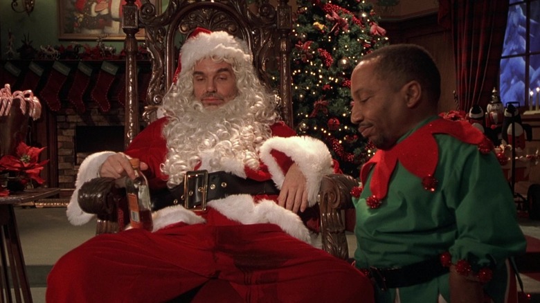 Billy Bob Thornton and Tony Cox as Willie and Marcus, dressed in their costumes and drinking together in Bad Santa