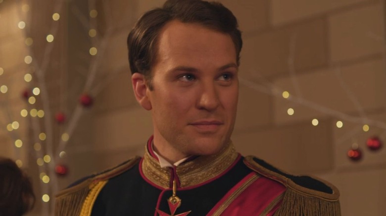 Ben Lamb as Prince Richard, smiling near lights in A Christmas Prince