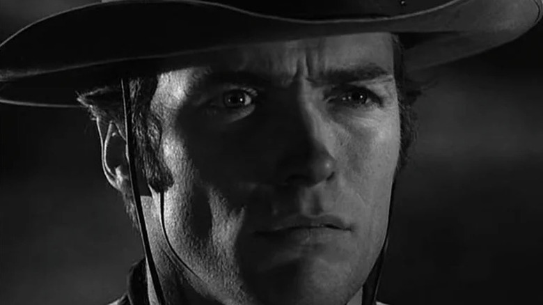 Rowdy Yates (Clint Eastwood) stares intensely ahead in the dark in Rawhide