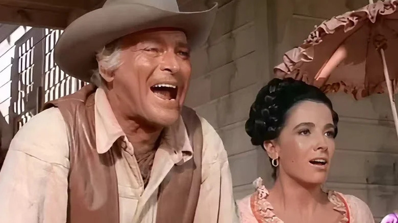John Cannon (Leif Erickson) shouts boisterously next to Victoria Montoya (Linda Cristal) in The High Chaparral