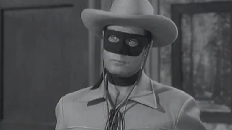The Lone Ranger (Clayton Moore) stands in his masked costume in The Lone Ranger