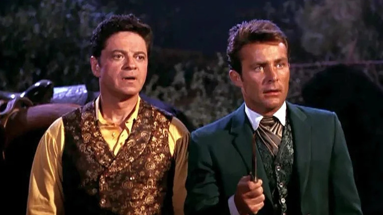 Artemus Gordon (Ross Martin) and James West (Robert Conrad) stand by their horses in The Wild Wild West