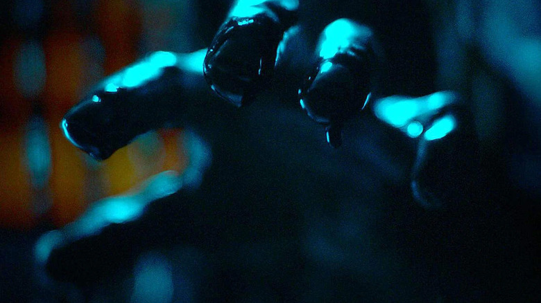 a bloody hand reaching toward us in Baskin