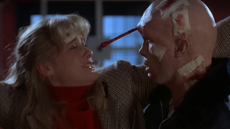 Barbara Crampton as Katherine and Jeffrey Combs as Crawford, interrupted by his brain worm in From Beyond
