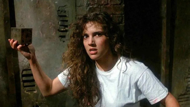 Ashley Laurence as Kirsty, threatening to destroy the box in Hellraiser