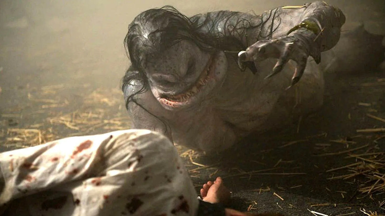 a merman about to eat Bradley Whitford as Hadley in The Cabin in the Woods