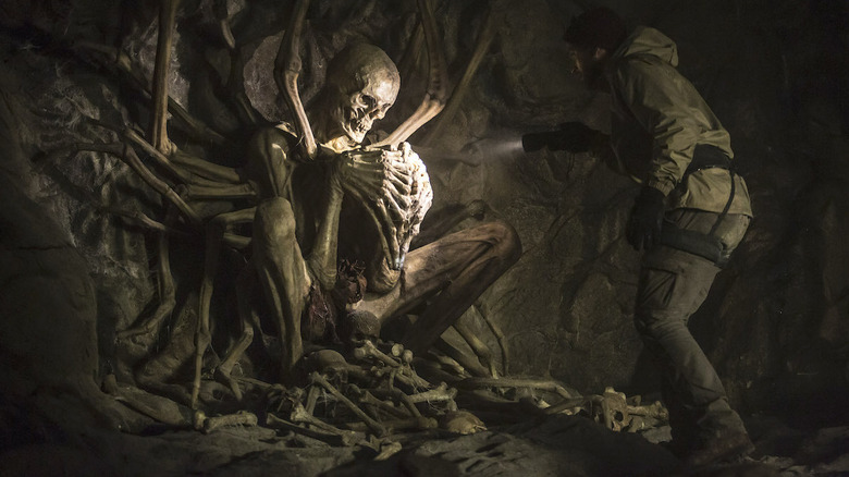 Aaron Poole as Paul, finding a huge ancient skeleton in The Empty Man