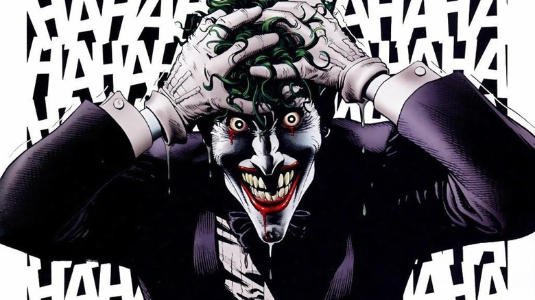 The Joker holding his head and laughing in Batman: The Killing Joke