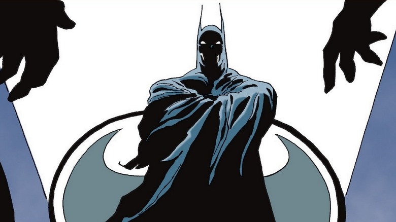Batman looking at two men in Batman: The Long Halloween