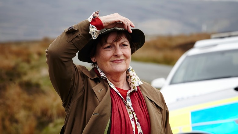 Vera Stanhope (Brenda Blethyn) holds her hat as she looks at the horizon in Vera