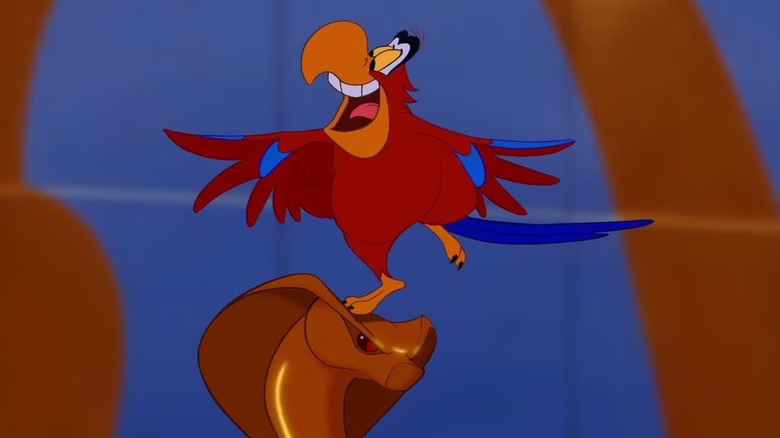 Iago balances on Jafar's staff in Aladdin