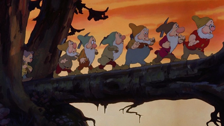 Dopey, Sneezy, Bashful, Sleepy, Happy, Grumpy, and Doc journey home from the mine in Snow White and the Seven Dwarves