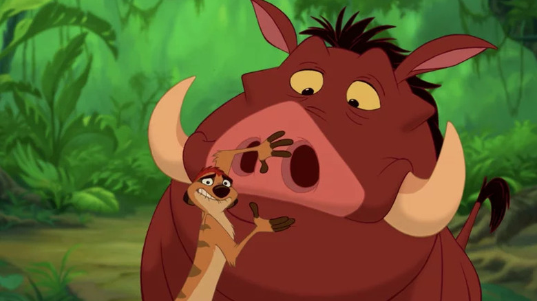 A nervous Timon tries to silence a concerned Pumbaa in The Lion King